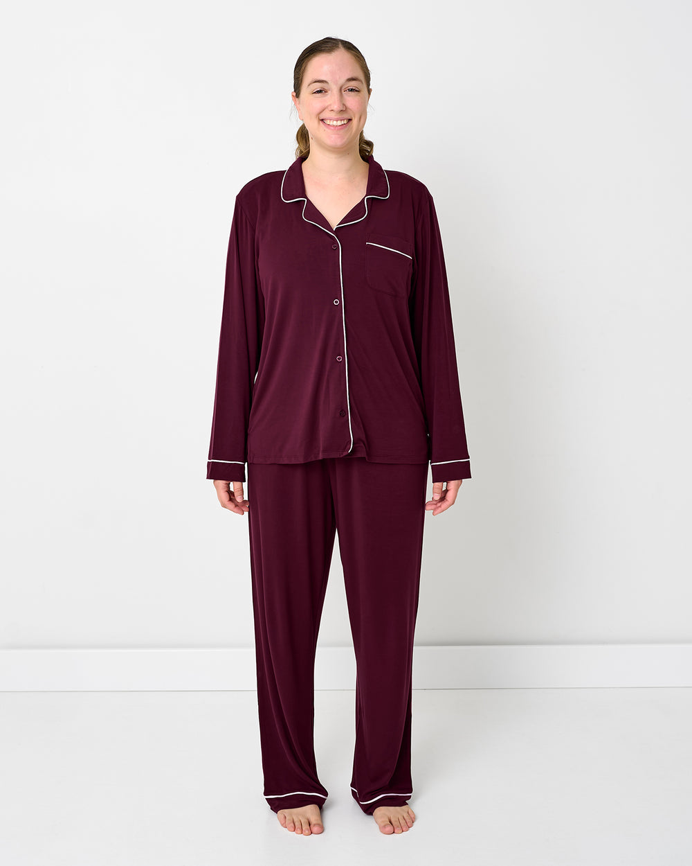 Standing woman wearing the Classic Burgundy Women's Long Sleeve Pajama Set