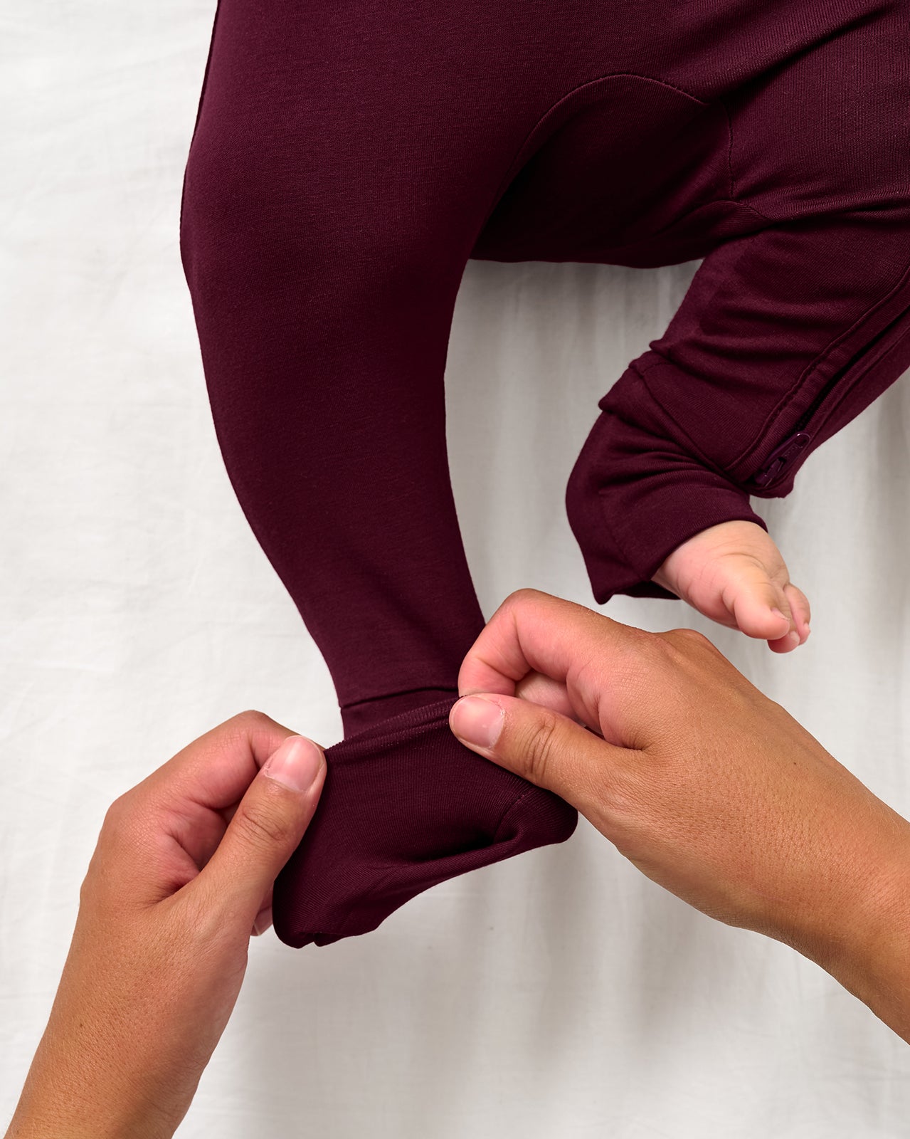 Adult demonstrating the foot fold over feature on the Classic Burgundy Zippy