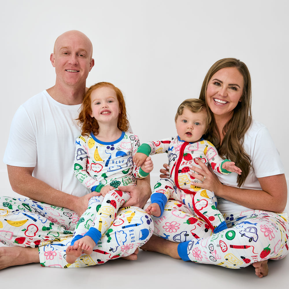 Family of four wearing matching Coloring Crew pajamas