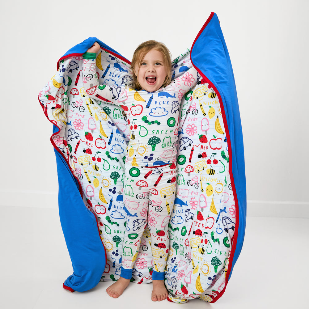 Child holding up the Coloring Crew Large Cloud Blanket®
