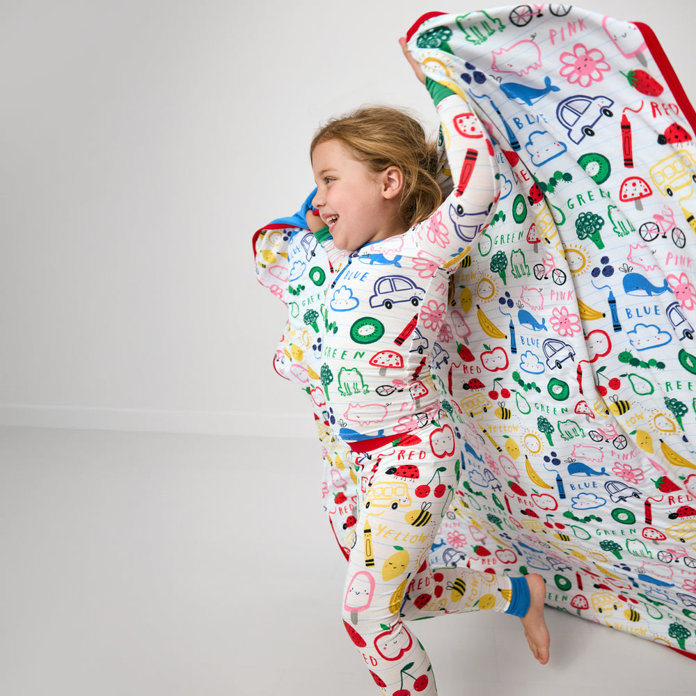 Child in motion wearing the Coloring Crew Large Cloud Blanket®