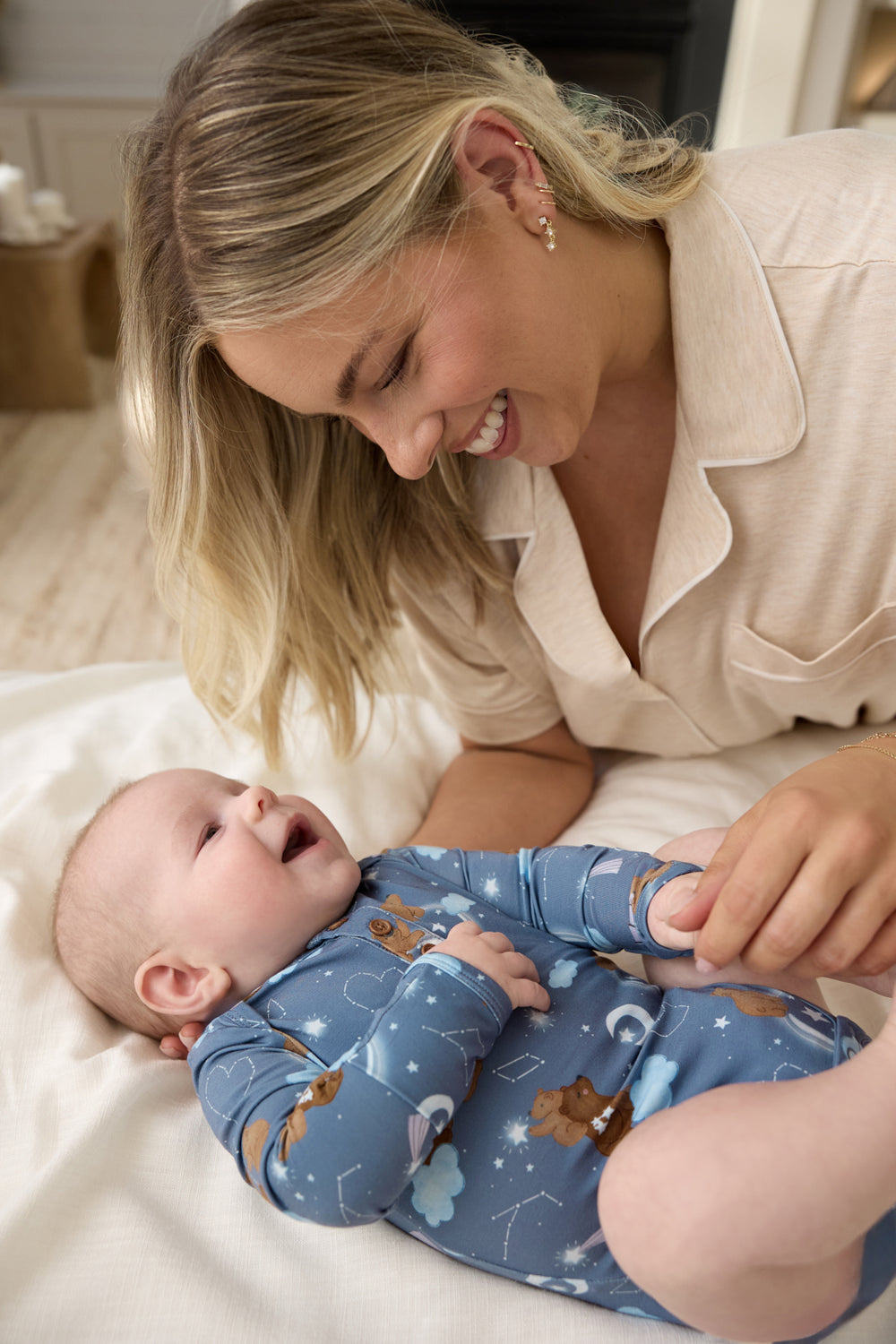 Mother holding baby wearing the Constellation Cubs Henley Bodysuit