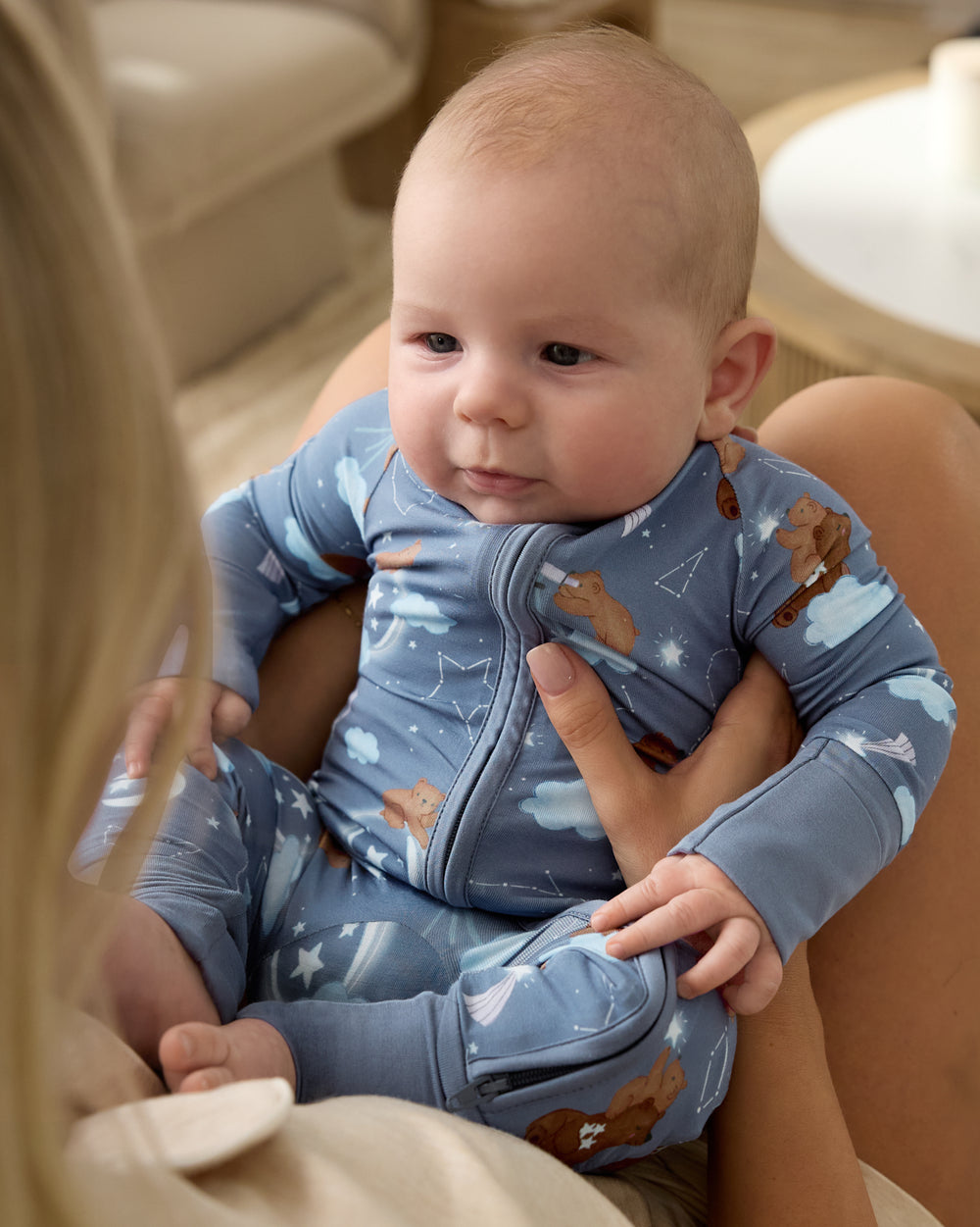 Baby being held wearing the Constellation Cubs Zippy