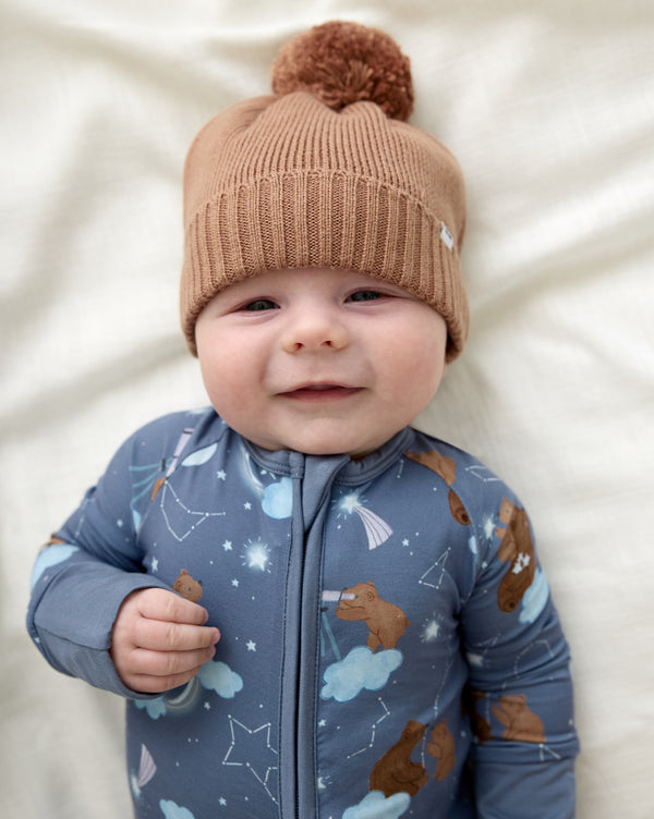 Newborn wearing the Chestnut Brown Sweater Beanie Hat with the Constellation Cubs zippy