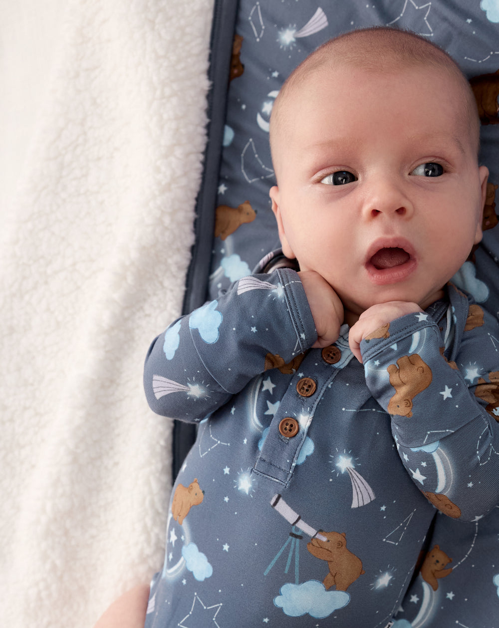 Close up of newborn wearing the Constellation Cubs Henley Bodysuit on a sherpa blanket