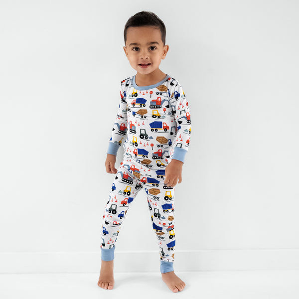 Standing child wearing the Construction Two-Piece Pajama Set