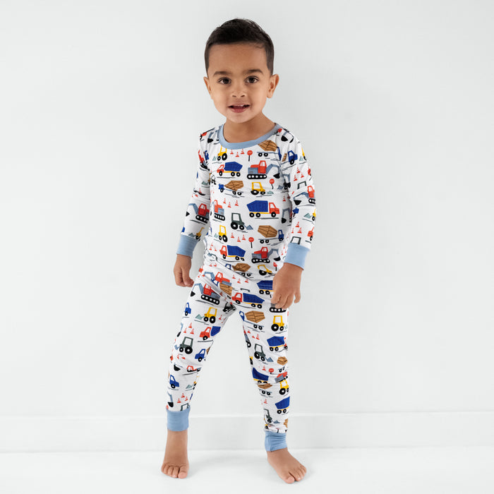 Standing child wearing the Construction Two-Piece Pajama Set