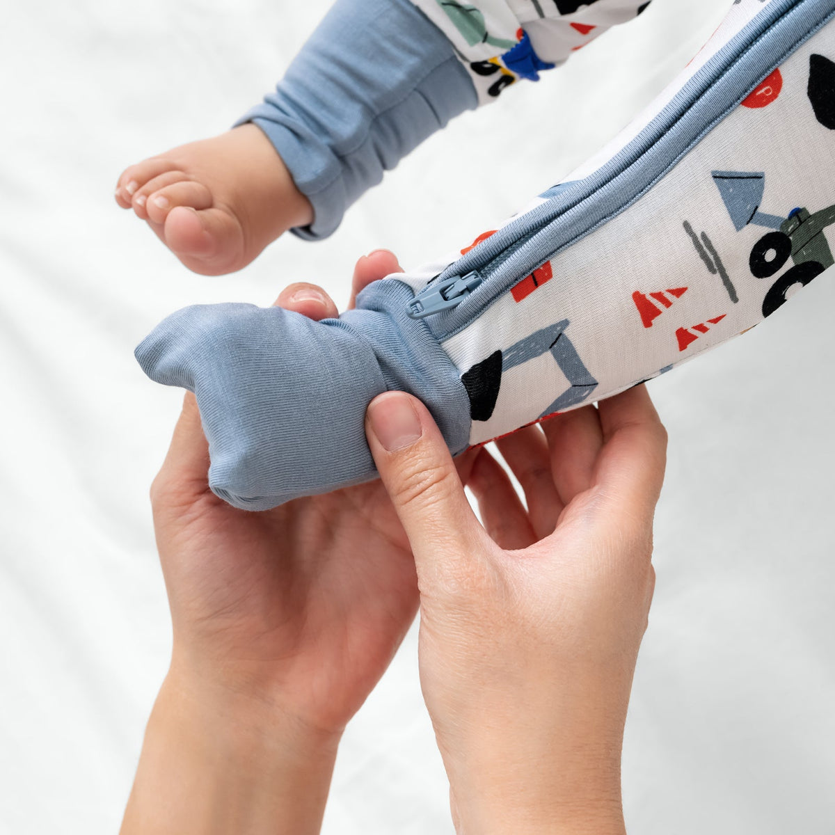Adult demonstrating the footie feature on the Construction Zippy