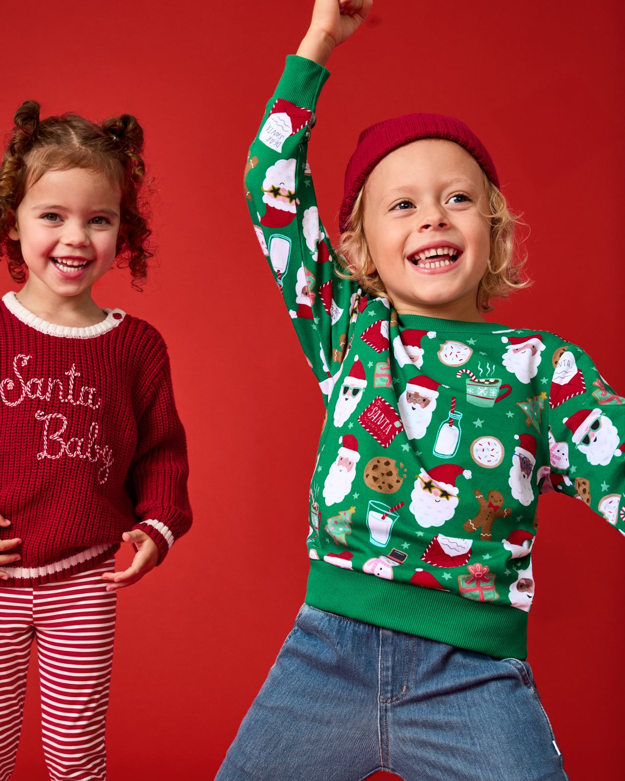 Child wearing the Cookies for Santa Crewneck Sweatshirt on a red background