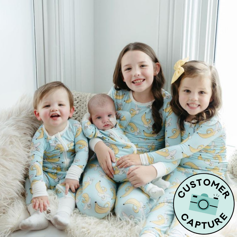 Customer capture image of four siblings wearing matching Bananas two piece pajama sets and zippy sets