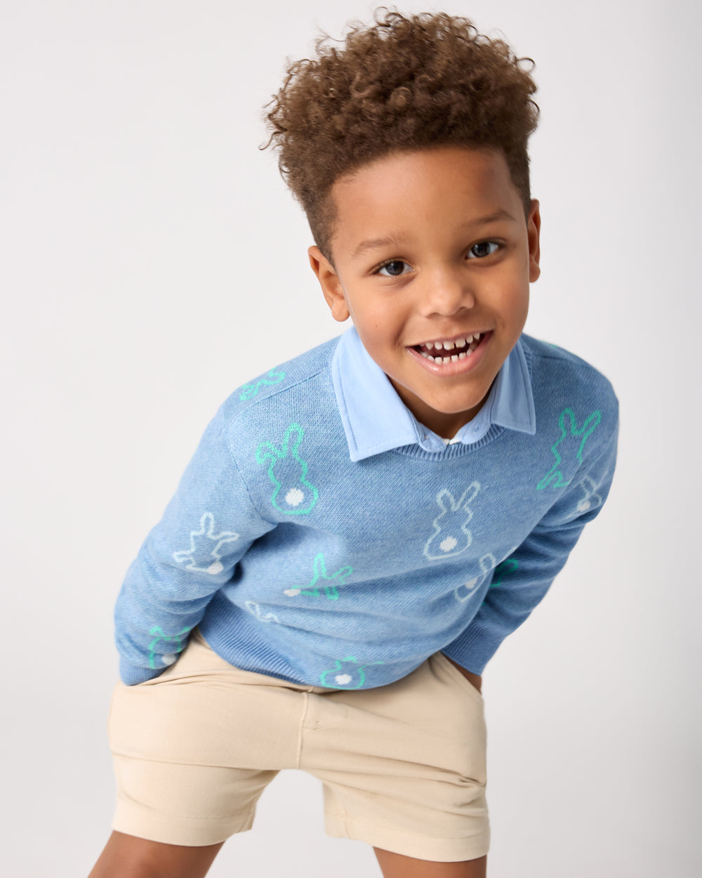 Boy wearing the Cozy Cottontails Sweater with khaki chino shorts