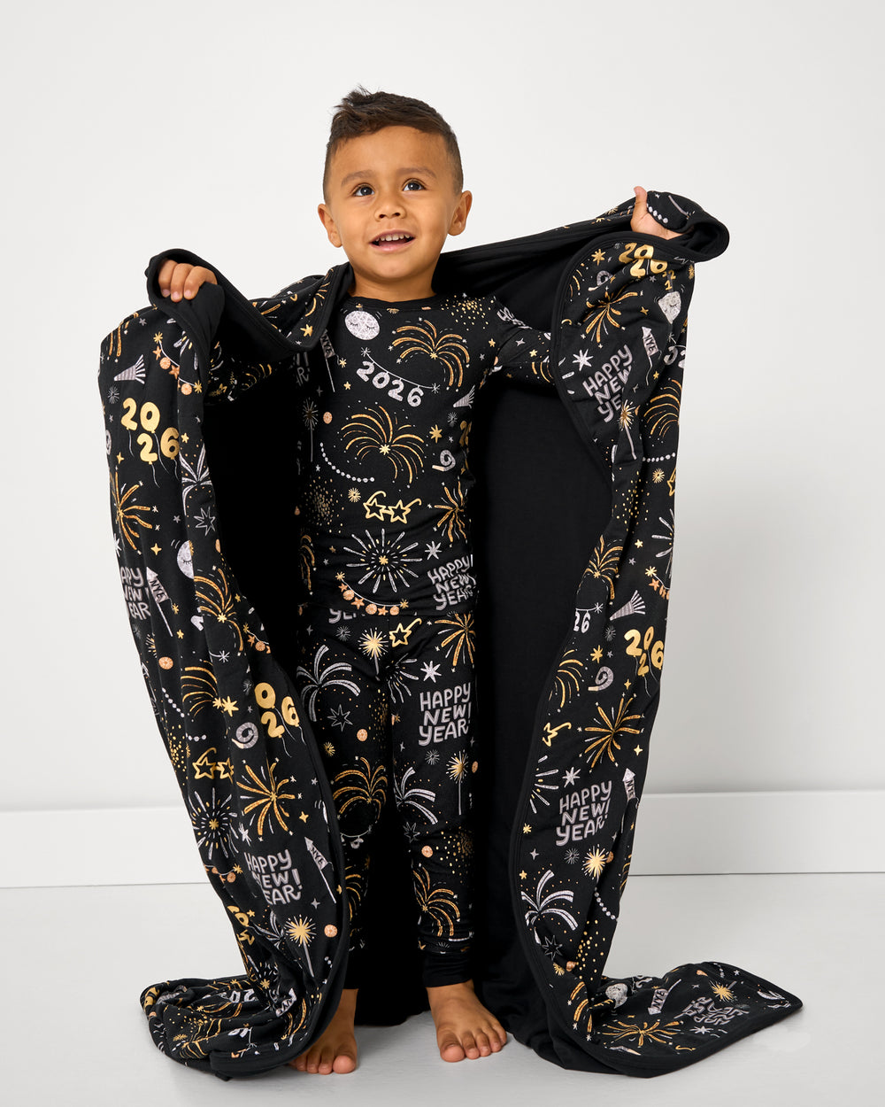 Boy holding up the Cozy Countdown Large Cloud Blanket®