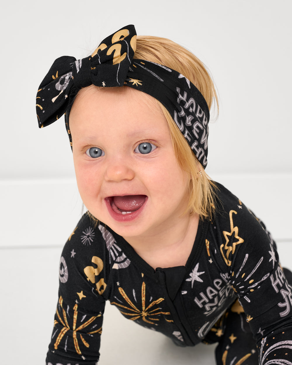 Crawling baby wearing the Cozy Countdown Luxe Bow Headband