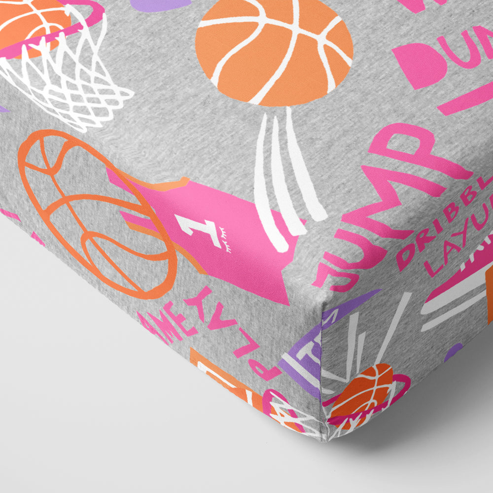 Corner view of the Pink Slam Dunk Crib Sheet