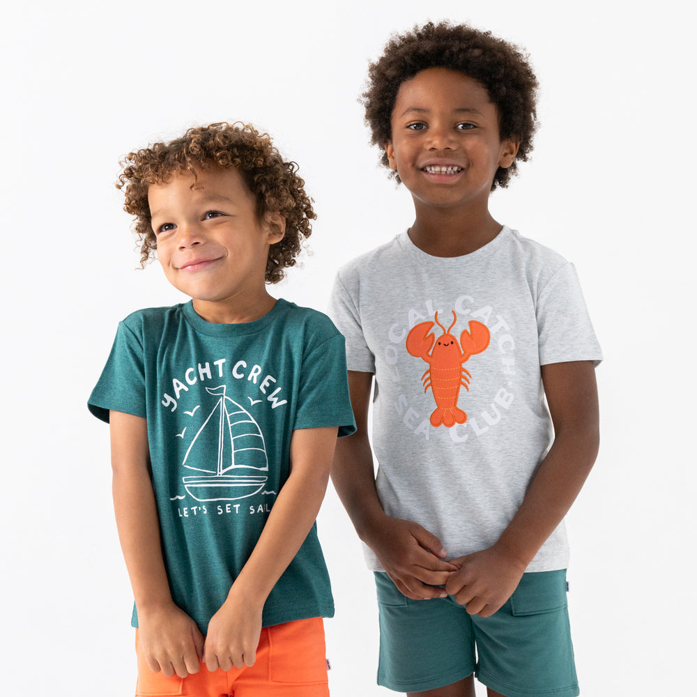 Two children wearing Local Catch and Yacht Crew graphic tees