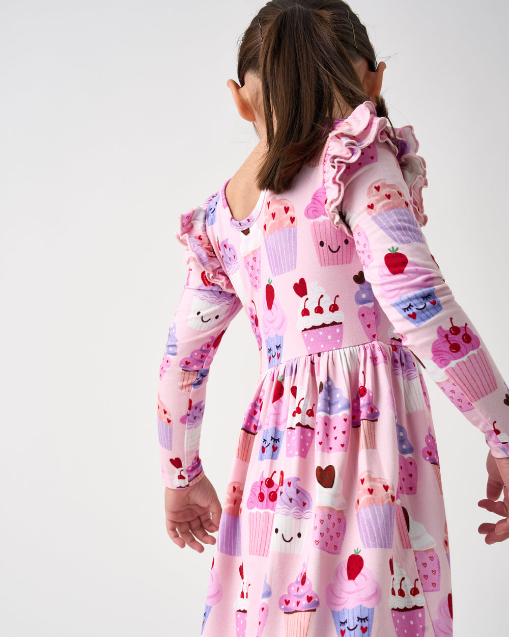 Back view of child wearing the Cupcake Kisses Flutter Skater Dress