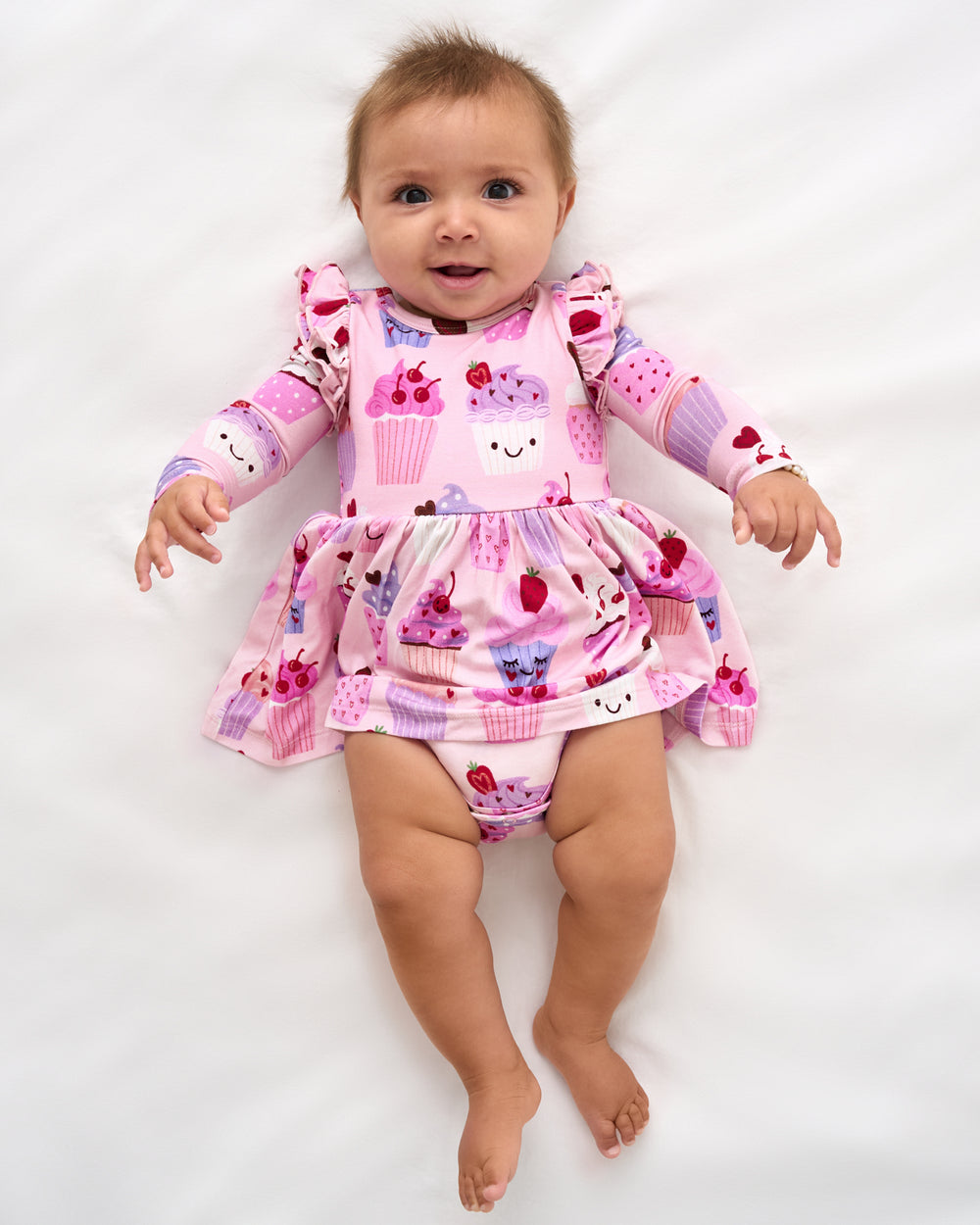 Aerial view of baby wearing the Cupcake Kisses Flutter Skater Dress with Bodysuit