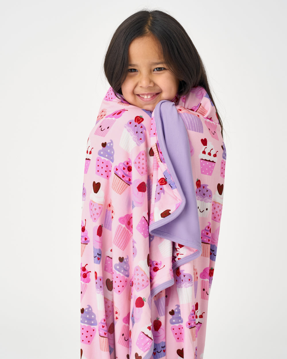 Close up of girl wrapped in the Cupcake Kisses Large Cloud Blanket®