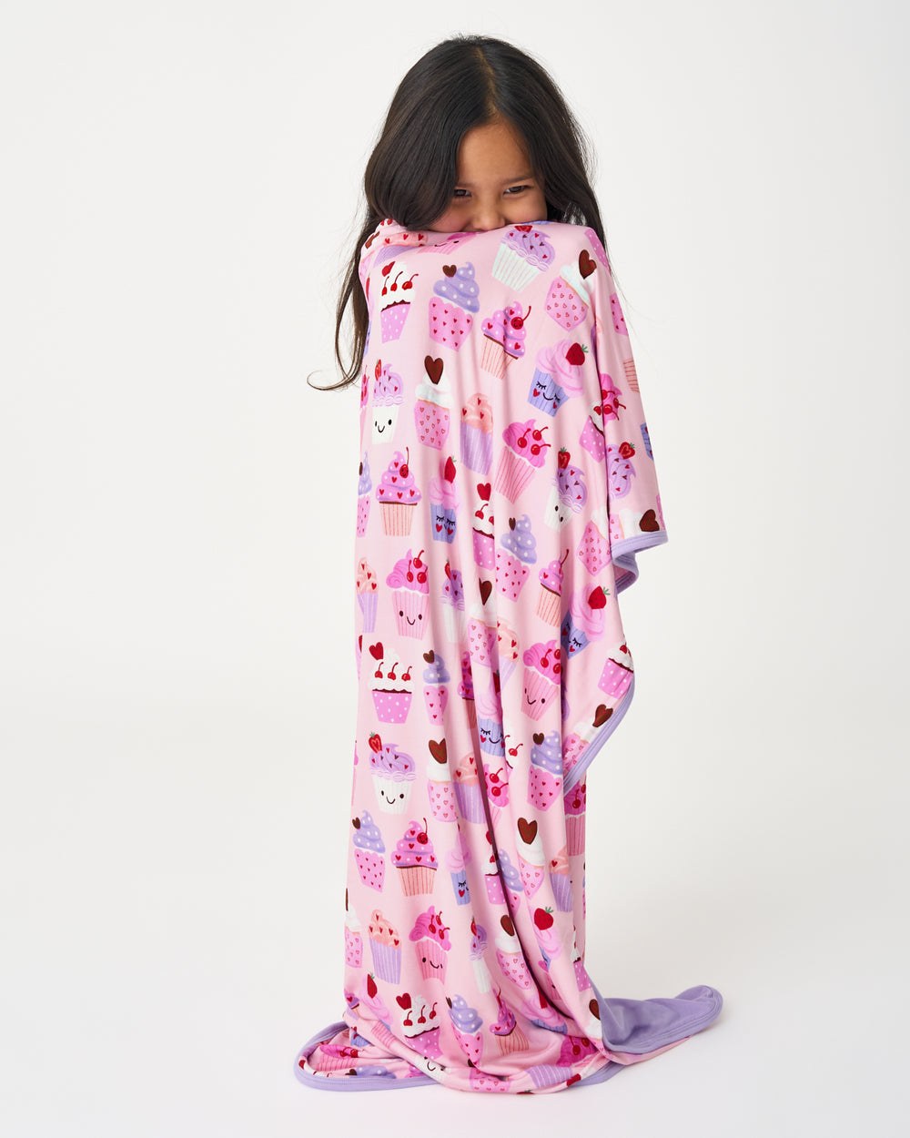 Standing girl wrapped in the Cupcake Kisses Large Cloud Blanket®