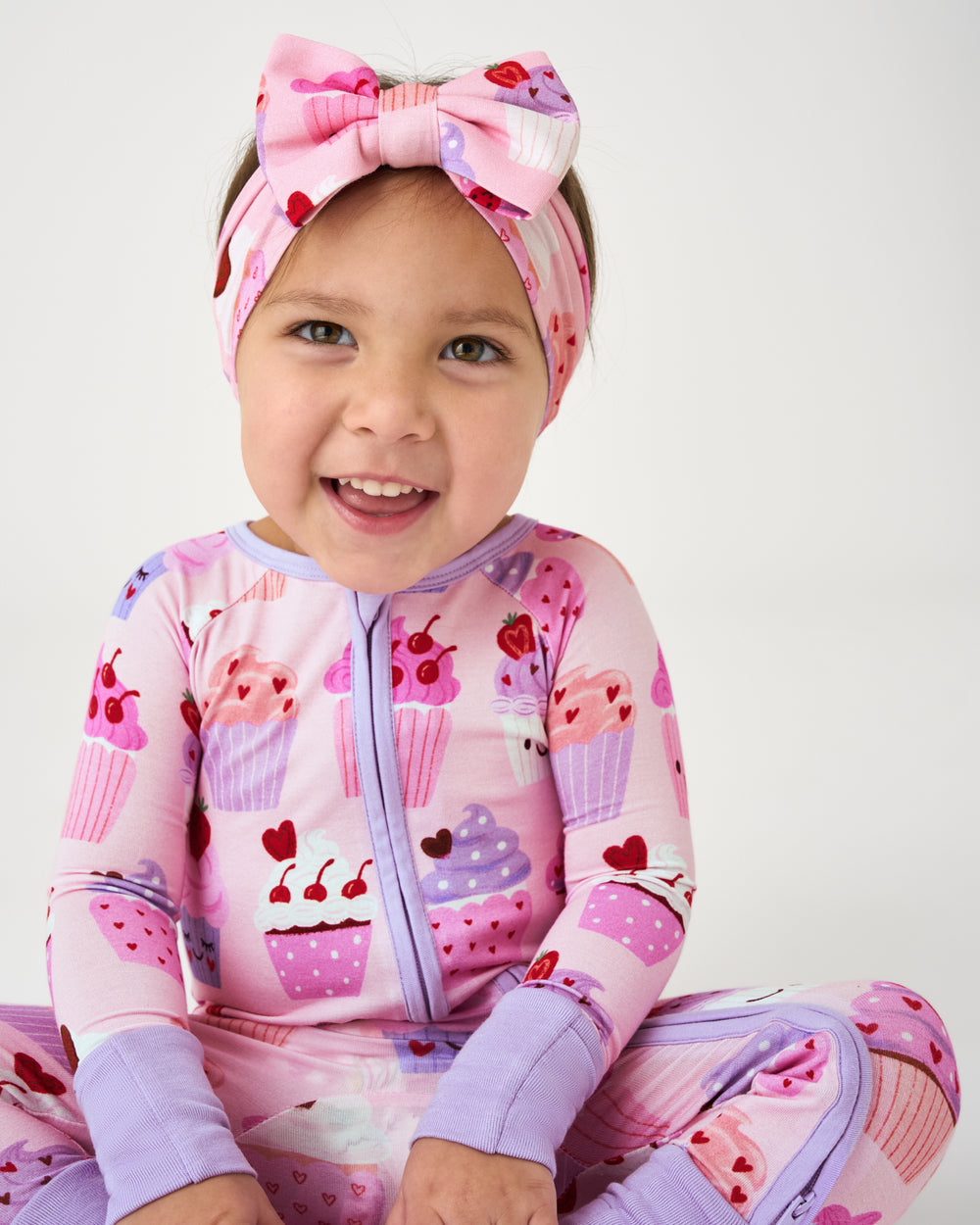 Sitting baby wearing the Cupcake Kisses Luxe Bow Headband