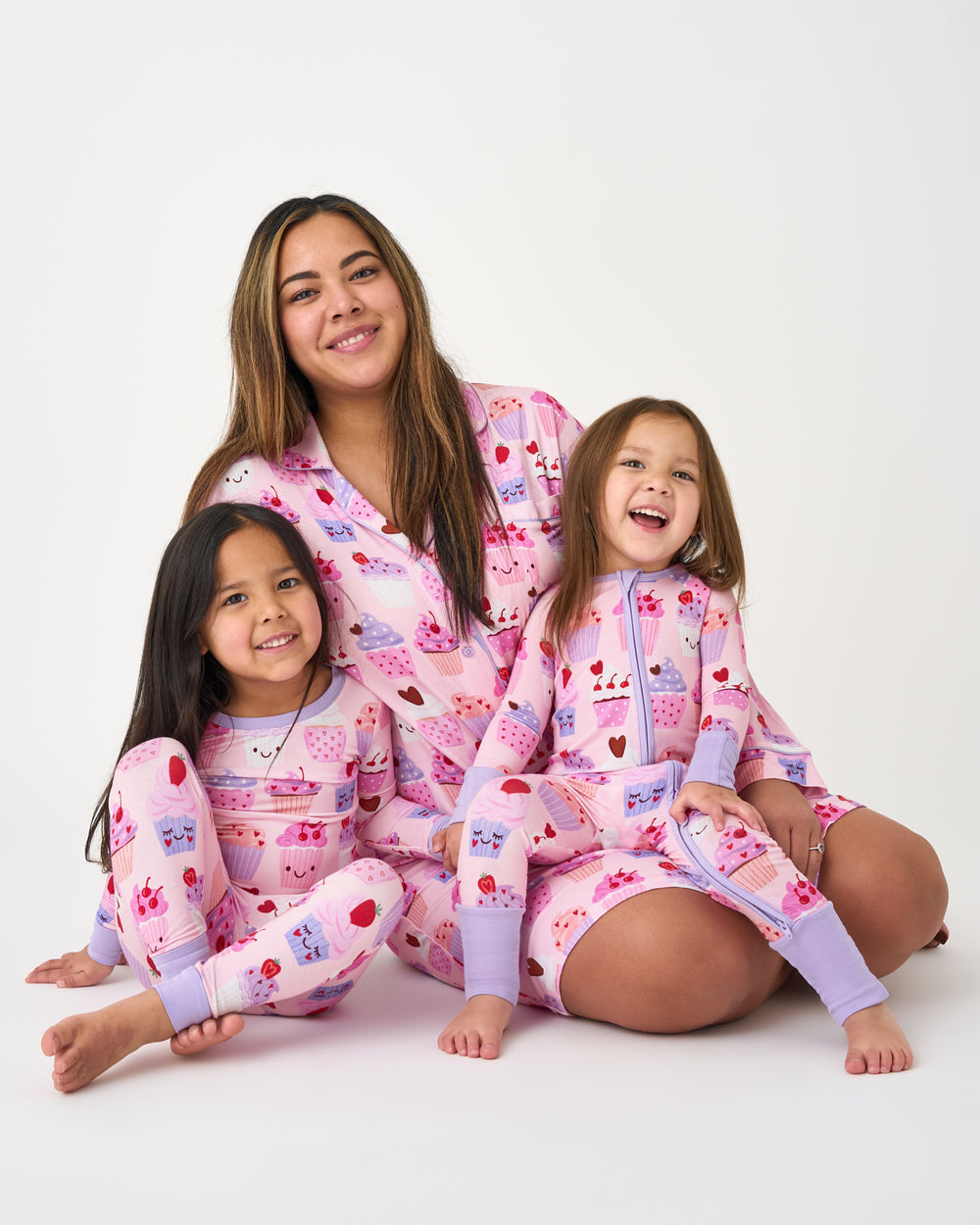 Family of three wearing matching Cupcake Kisses Valentines Day Pajamas