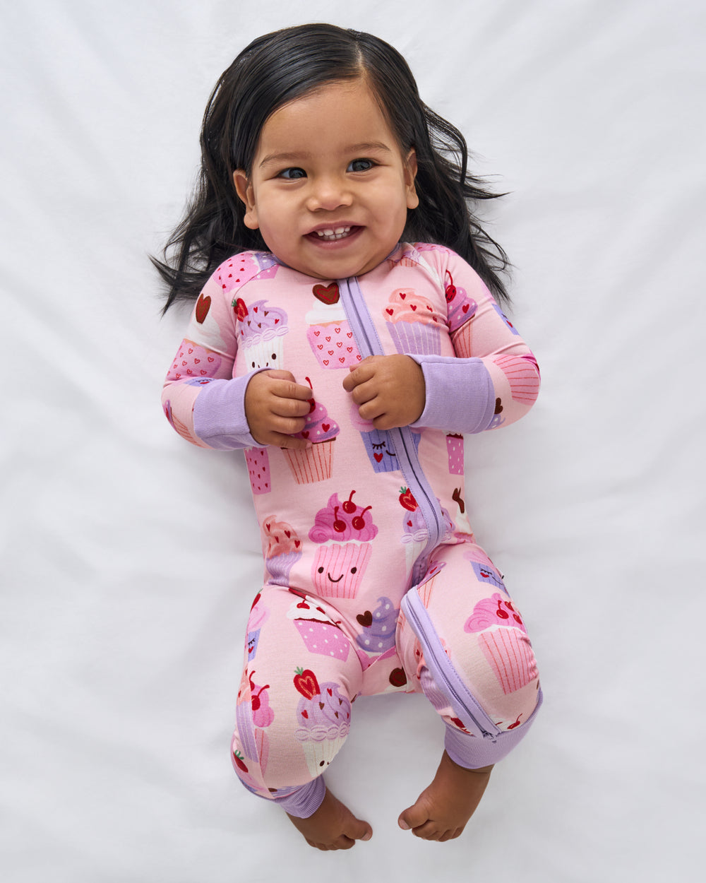 Aerial view of baby wearing the Cupcake Kisses Zippy