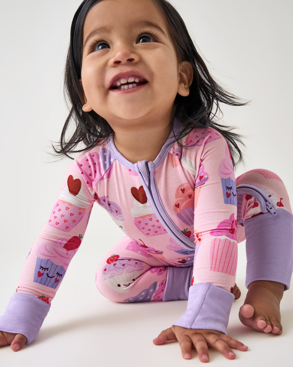 Crawling baby wearing the Cupcake Kisses Zippy