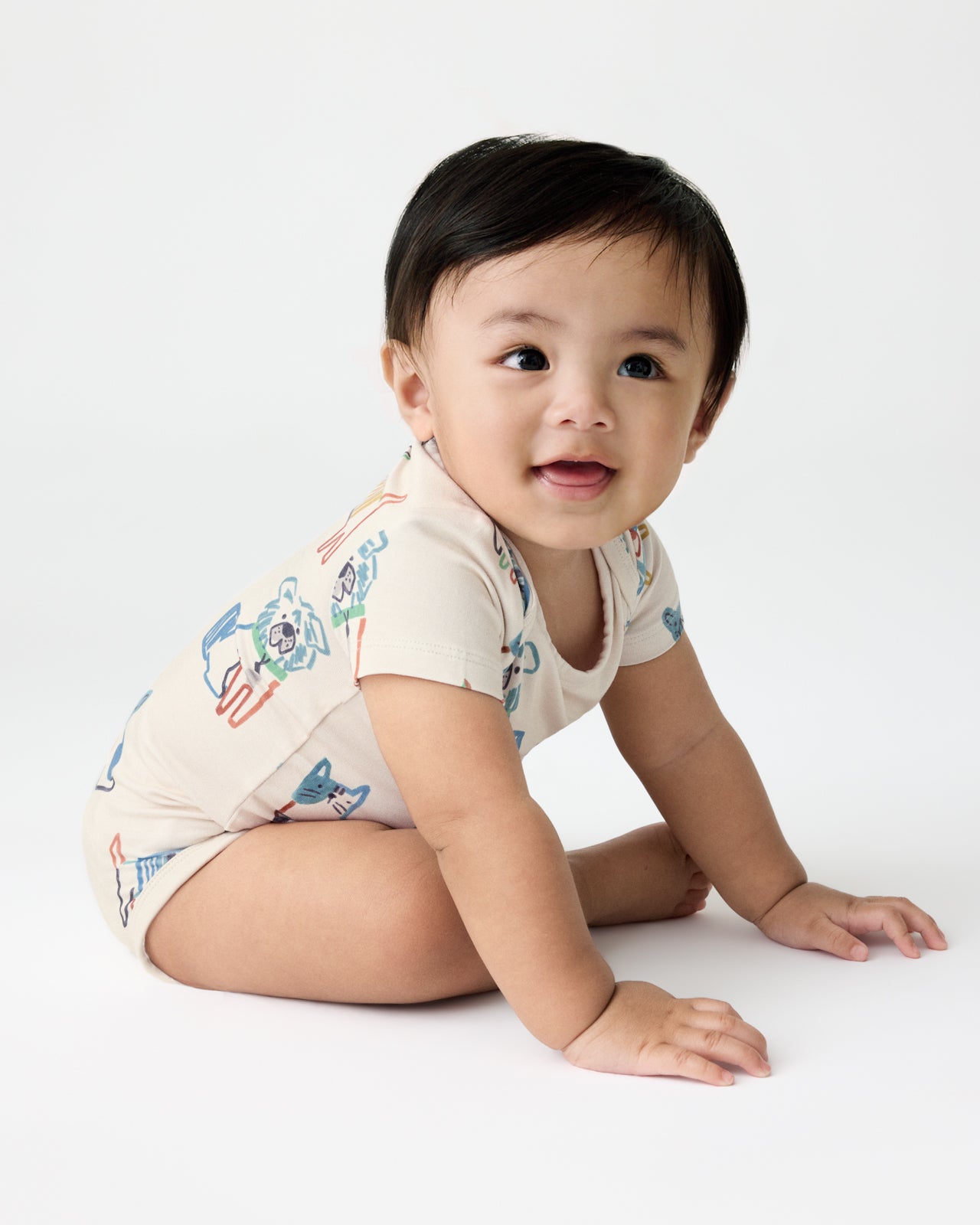 Sitting baby wearing the Whiskers & Wags Bodysuit