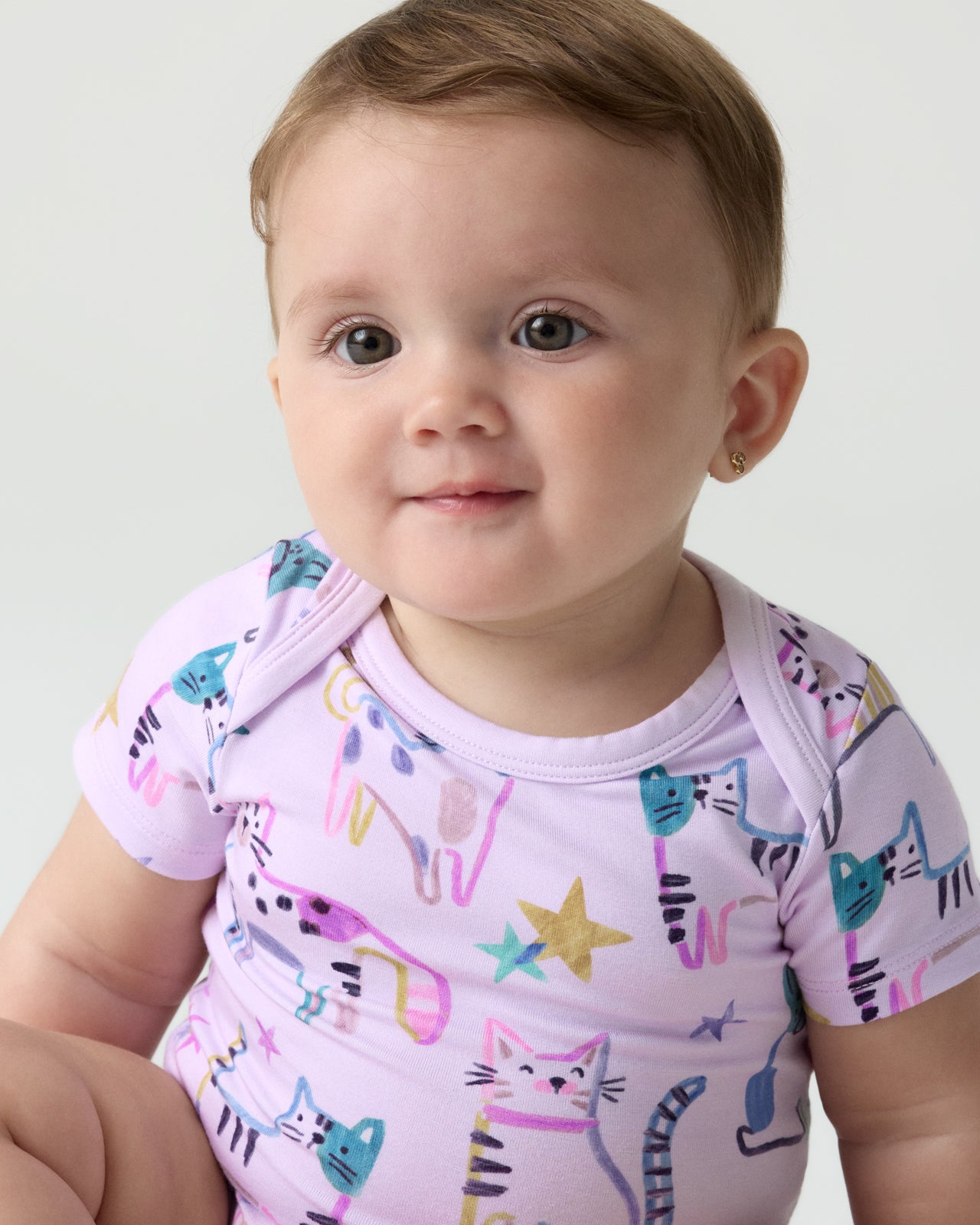 Close up of baby wearing the Whiskers & Wags Purple Bodysuit