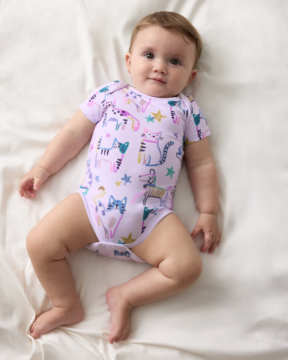 Aerial view of baby wearing the Whiskers & Wags Purple Bodysuit