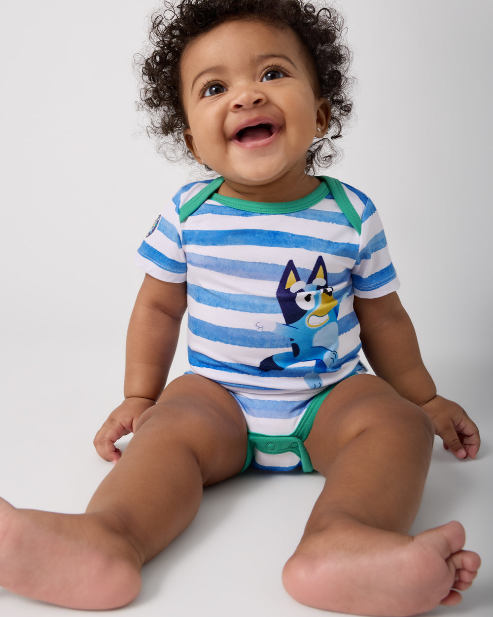 Sitting baby wearing the Bluey Bodysuit