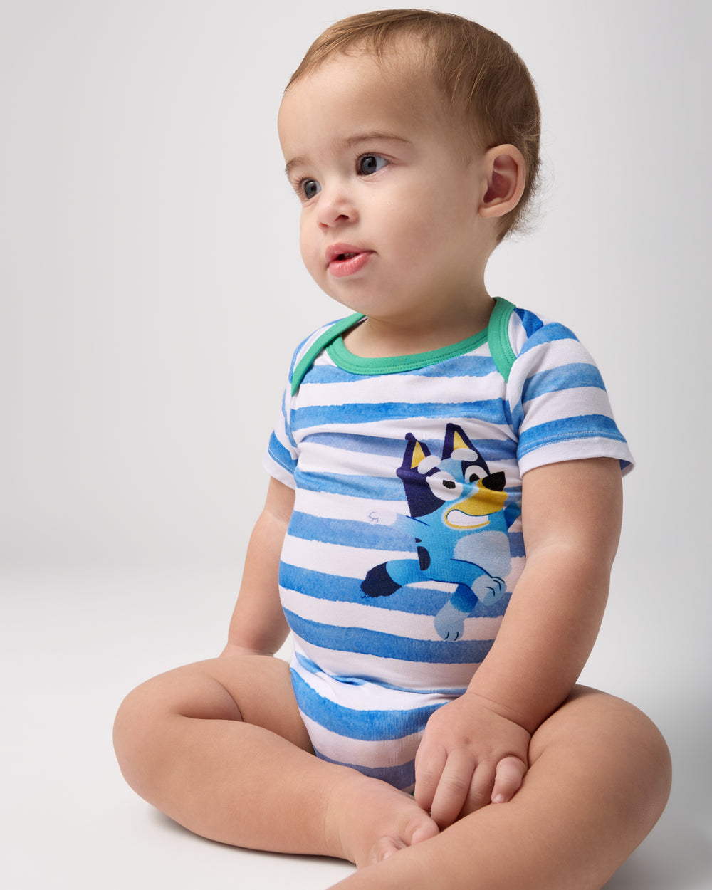 Alternate sitting baby wearing the Bluey Bodysuit