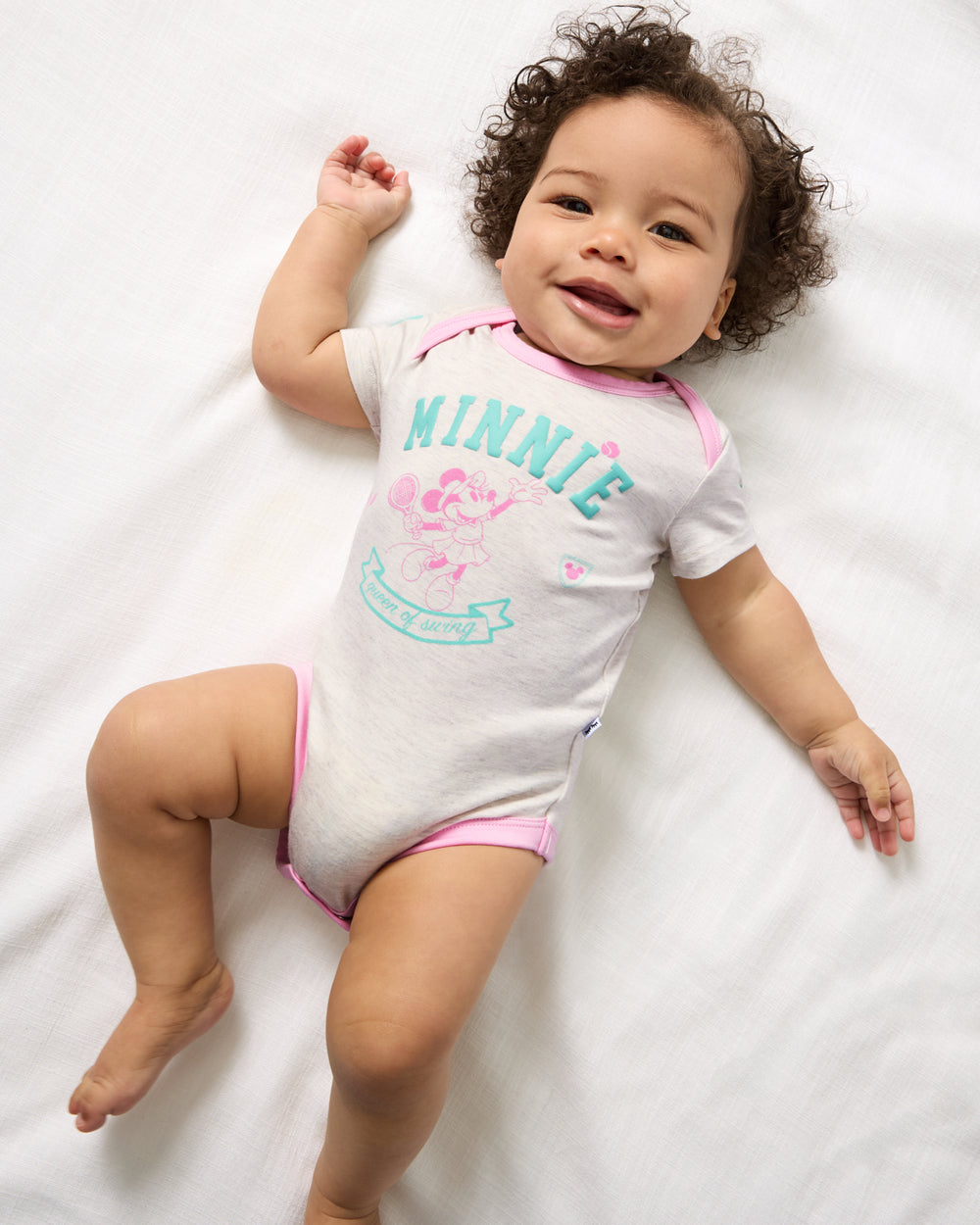 Aerial view of baby wearing the Disney Minnie Mouse Queen of Swing Bodysuit