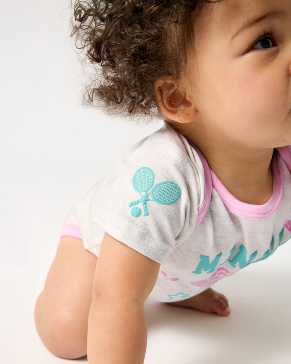 Crawling baby wearing the Disney Minnie Mouse Queen of Swing Bodysuit
