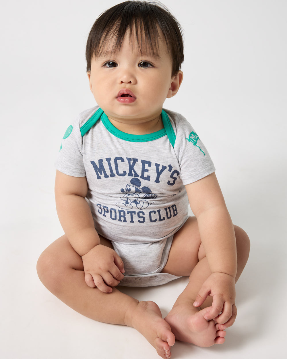 Sitting baby wearing the Disney Mickey Mouse Sports Club Bodysuit