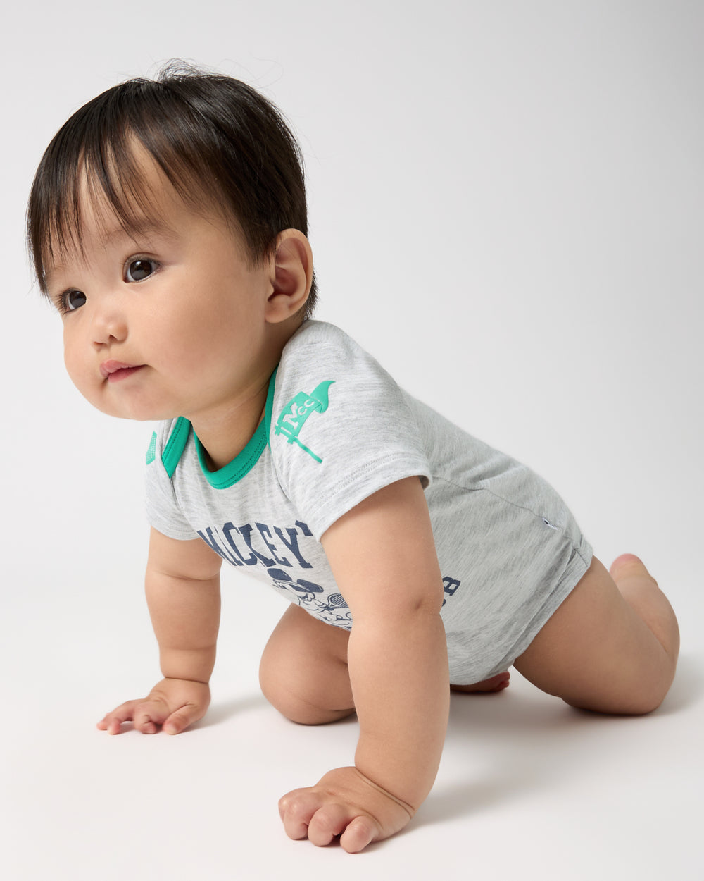 Crawling baby wearing the Disney Mickey Mouse Sports Club Bodysuit