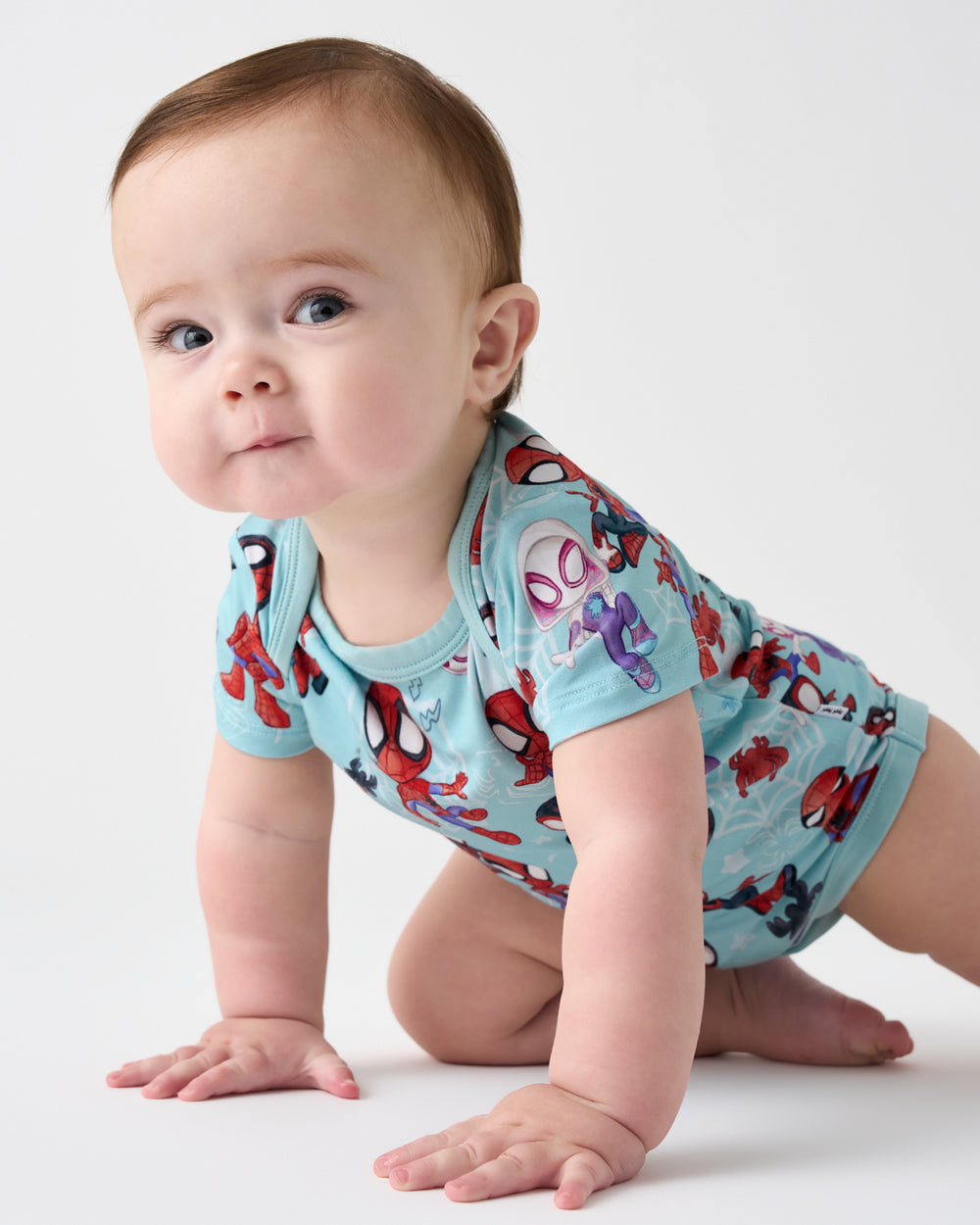 Crawling baby wearing the Spidey & Friends Tiny Webs Short Sleeve Bodysuit