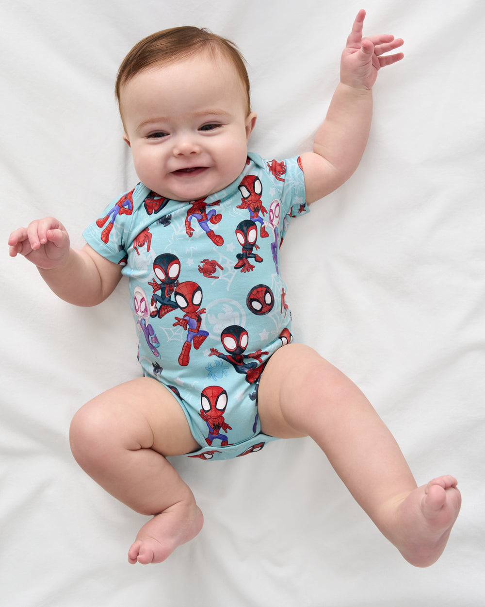 Overhead view of newborn wearing the Spidey & Friends Tiny Webs Short Sleeve Bodysuit