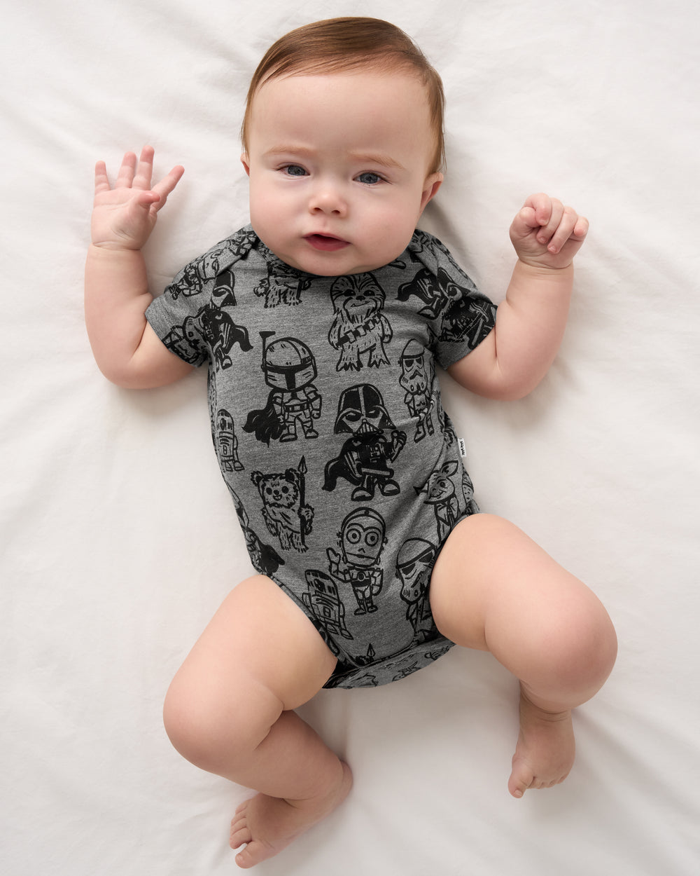 Aerial view of baby wearing the Star Wars Far, Far, Away Friends Short Sleeve Bodysuit