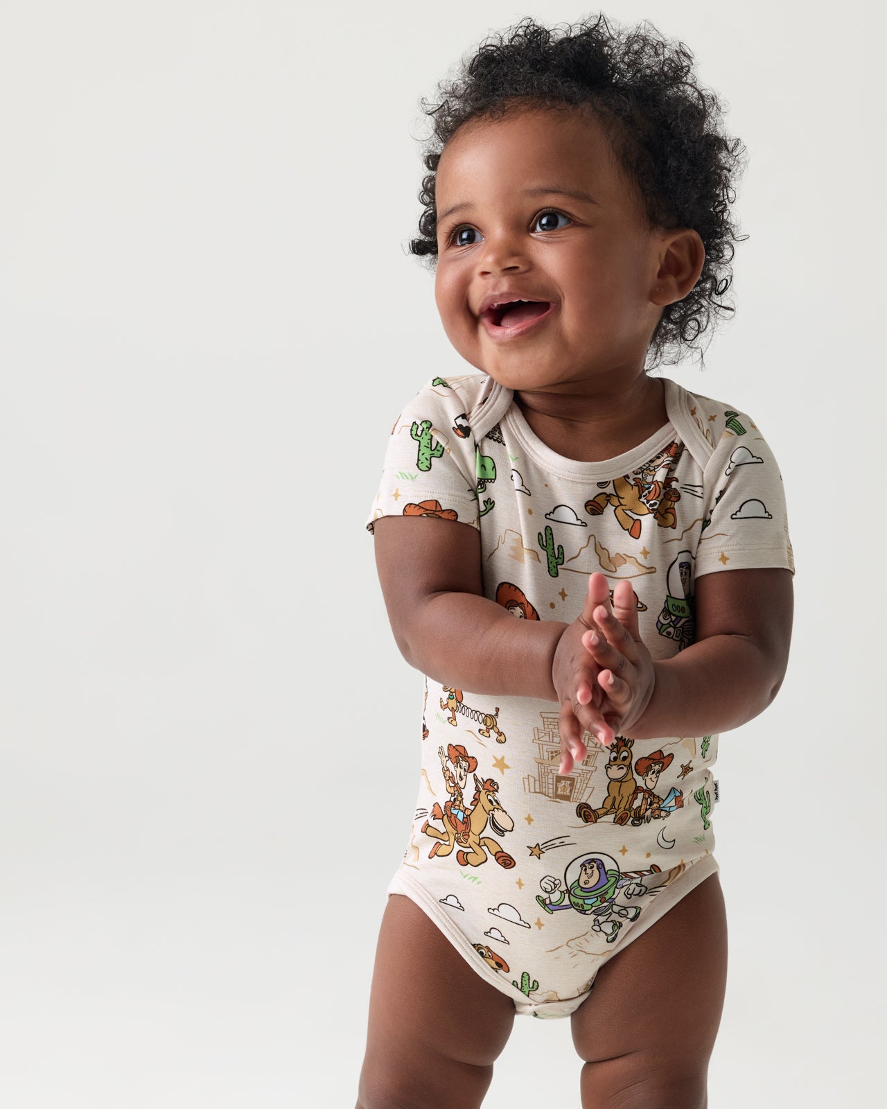Baby wearing the Disney & Pixar Woody's Wild West Bodysuit