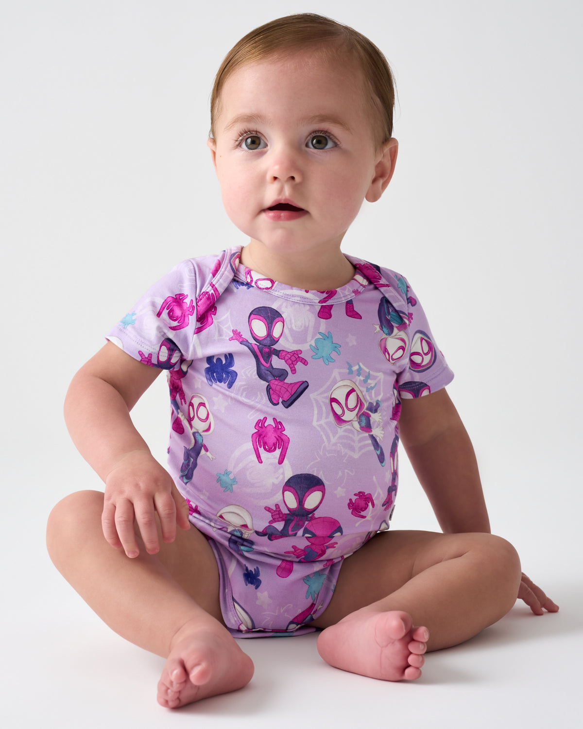 Sitting baby wearing the Spidey & Friends Tiny Webs Short Sleeve Bodysuit