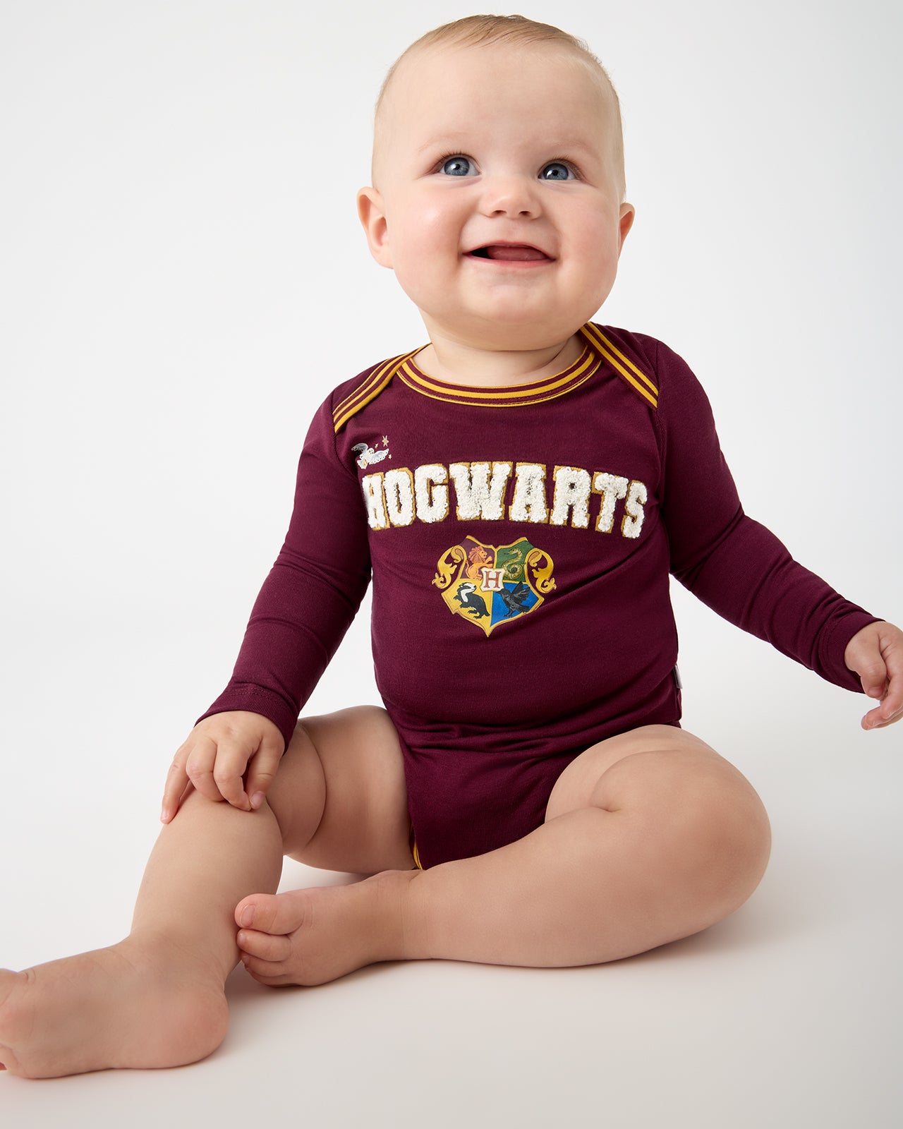 Baby wearing the Harry Potter™ Spellbinding Studies Bodysuit
