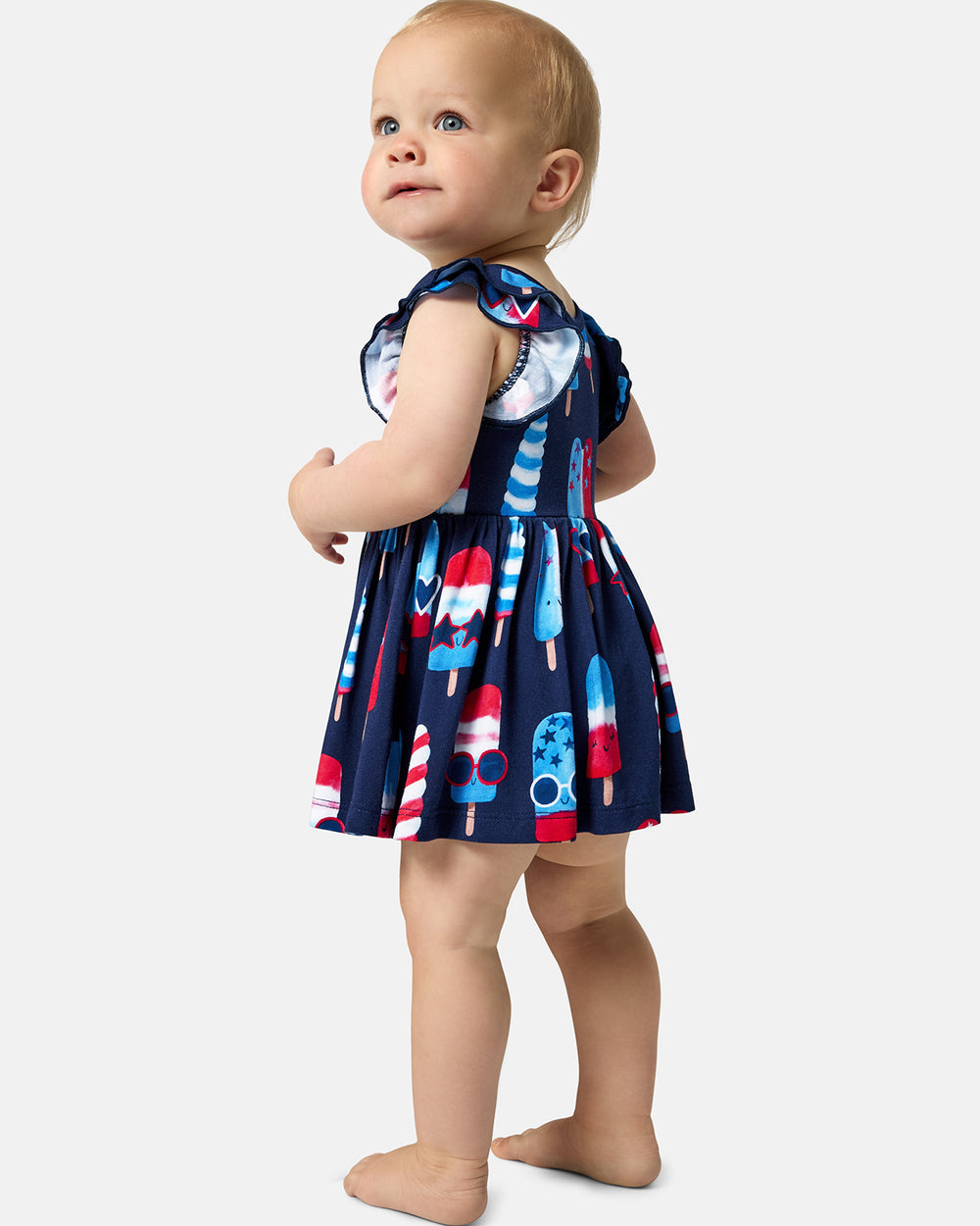 Standing baby wearing the Sparkle Treats Flutter Skater Dress with Bodysuit