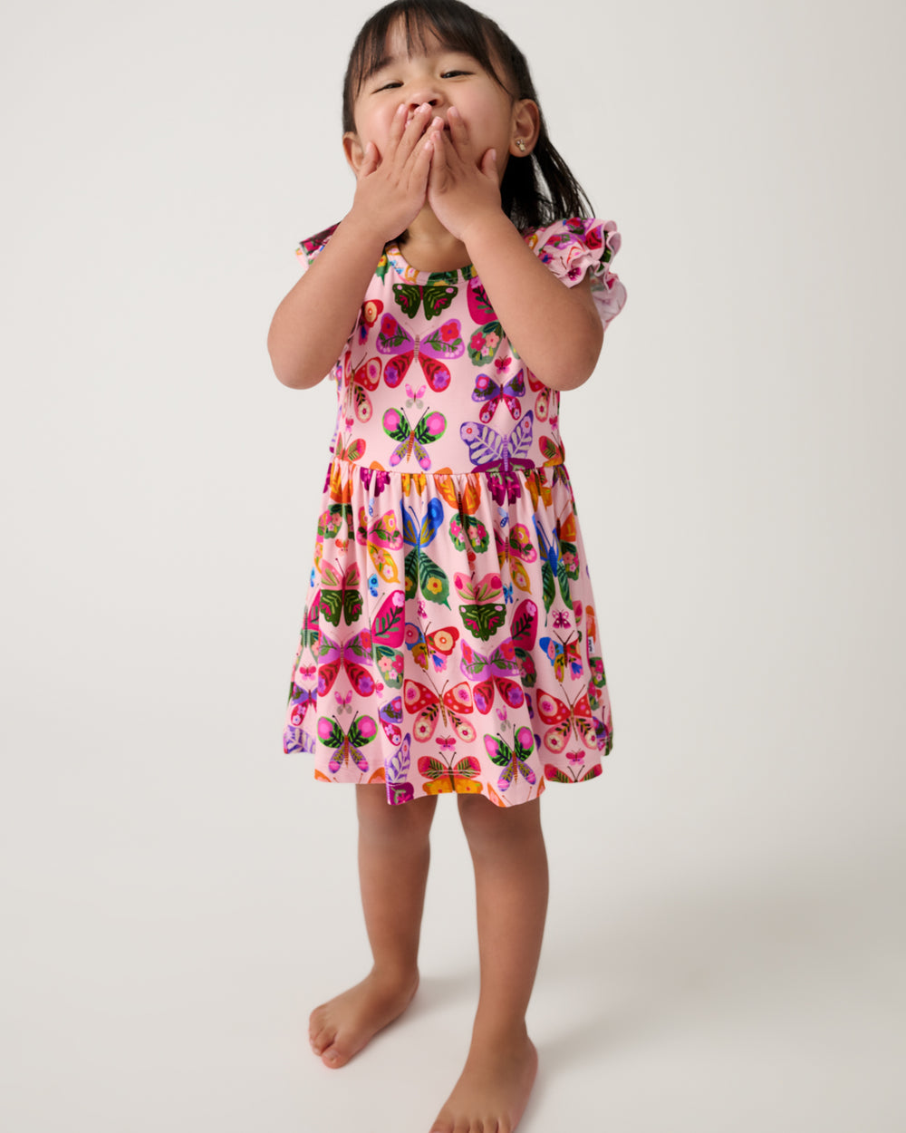 Girl wearing the Flutter Garden Skater Dress with Bodysuit