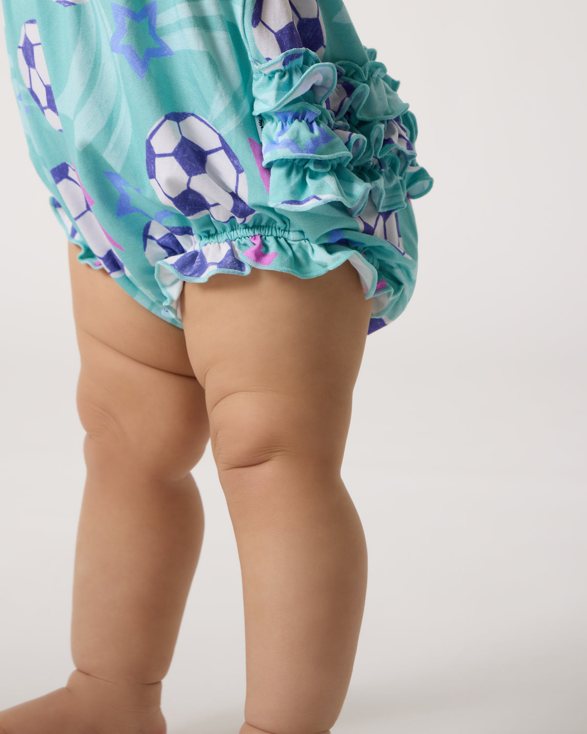 Close up of the ruffle detail on the Aqua Soccer Stars Bubble Romper