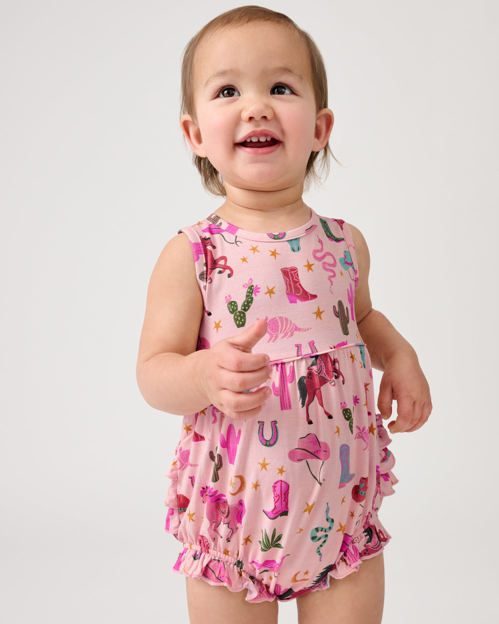 Standing toddler wearing the Pink Rancher Roundup Bubble Romper