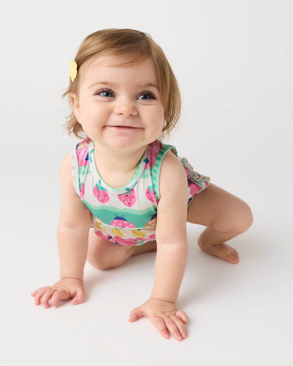 Crawling baby wearing the Ladybug Lane Bubble Romper