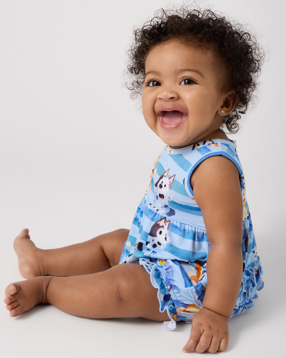 Sitting baby wearing the Bluey Dance All Day Bubble Romper
