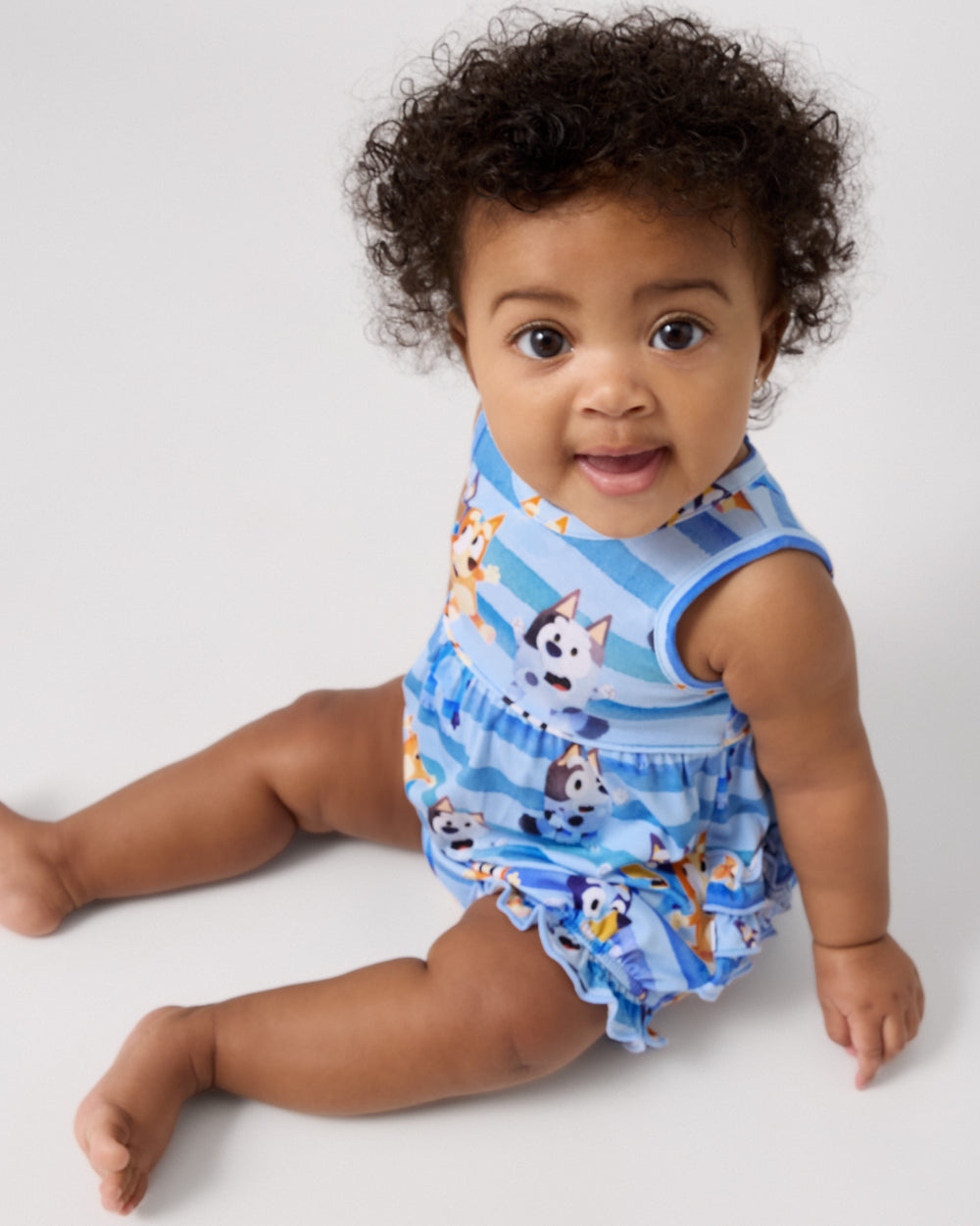 Sitting baby wearing the Bluey Dance All Day Bubble Romper