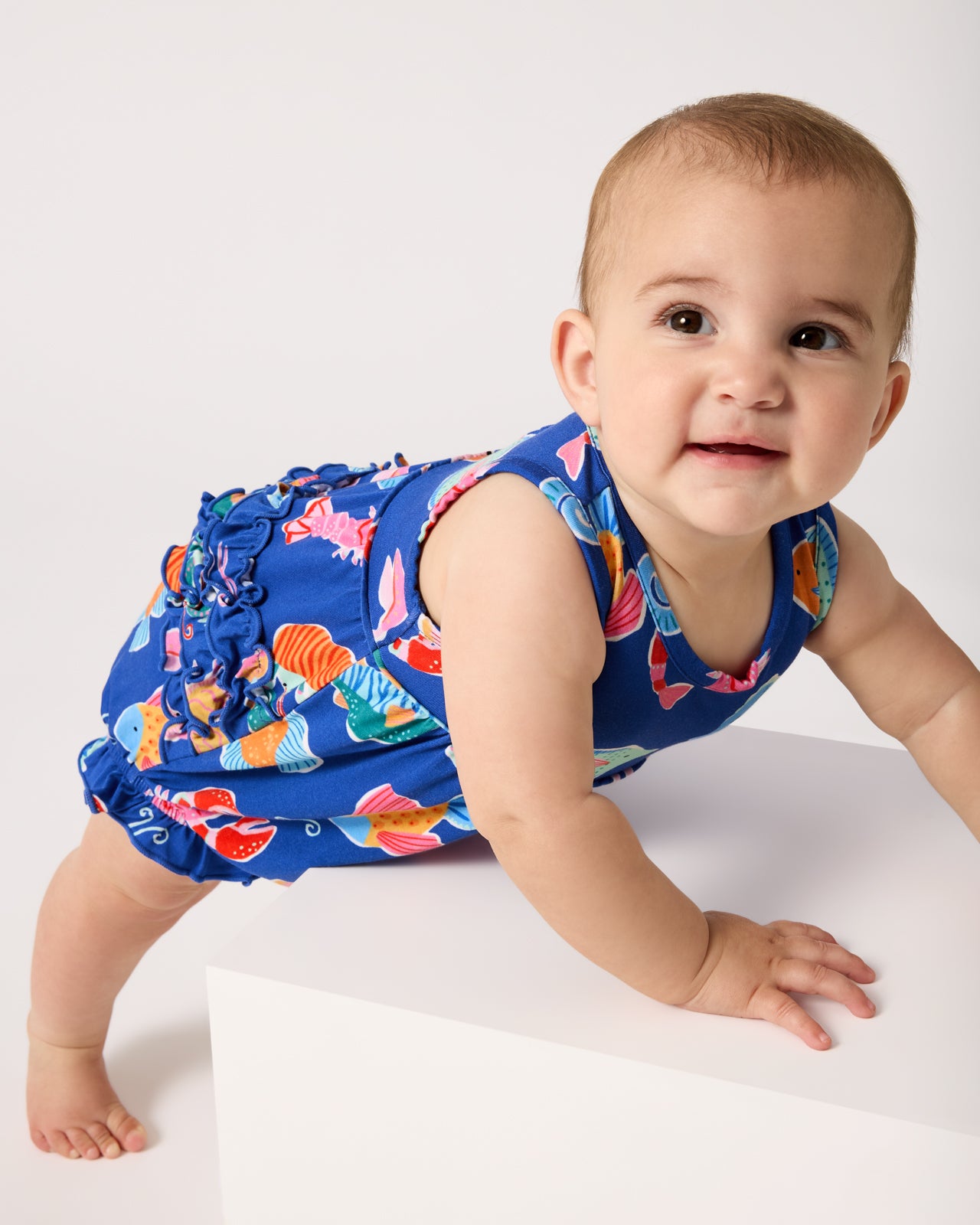 Crawling baby wearing the Tidepool Party Bubble Romper